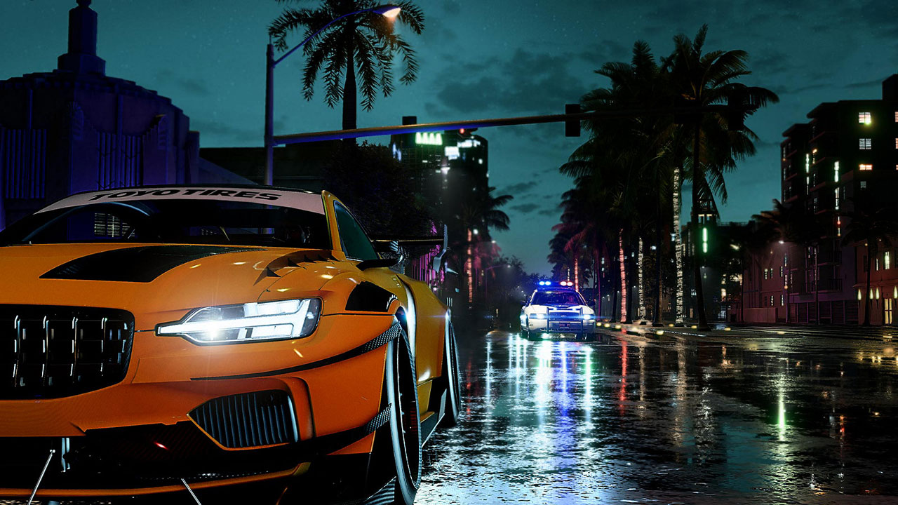 A yellow racing car on a wet street lined with palm tree, behind it is an approaching police car with emergency light on